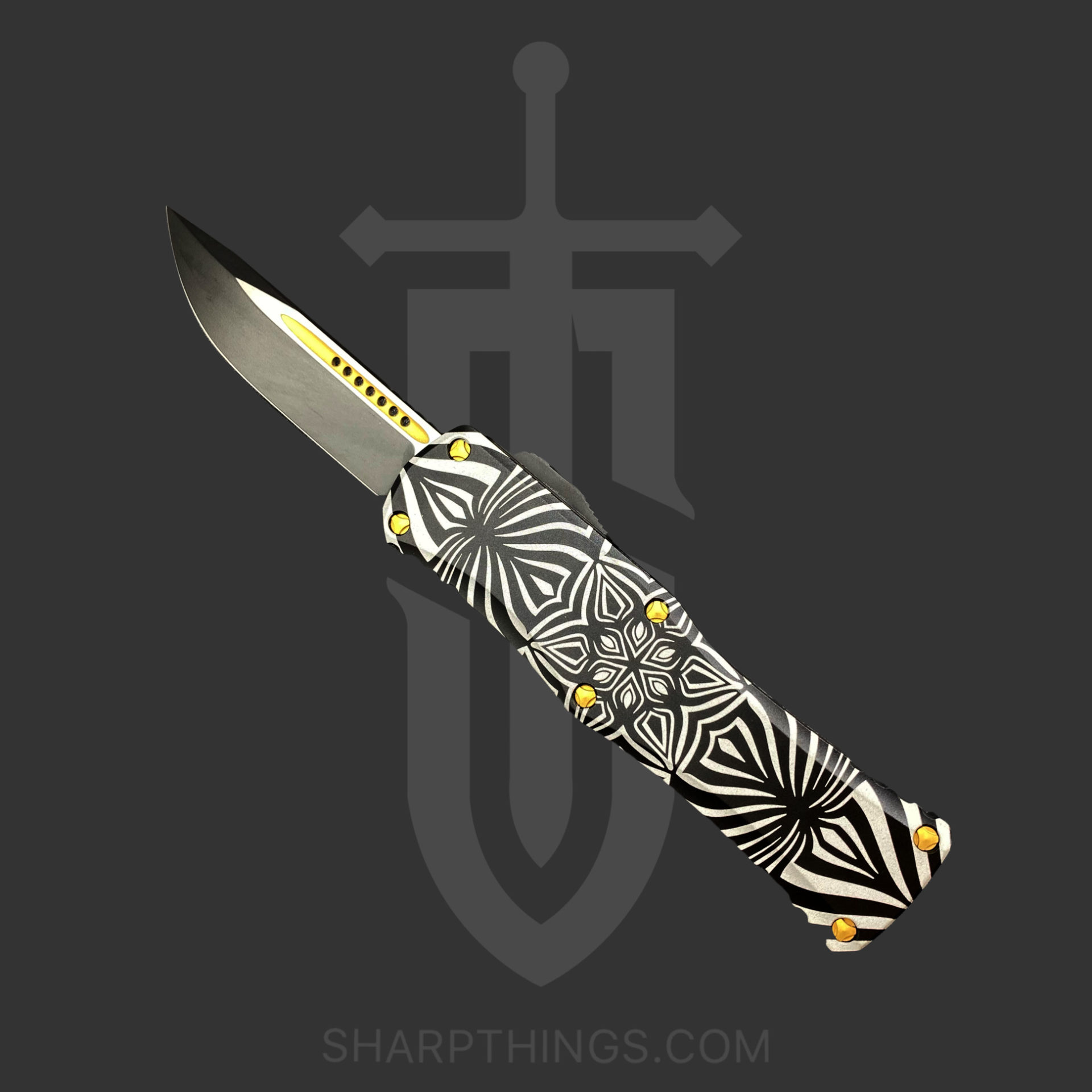 4663517e-18a8-4444-8be3-0b1f58e4dc01_703-1TSOS_1.jpg Microtech - 703-1TSOS - Hera Blade Show Signature Series - OTF Auto - M390 Two Tone Drop Point - 6061-T6 Aluminum/Artwork - Black/White/Gold - Image 1