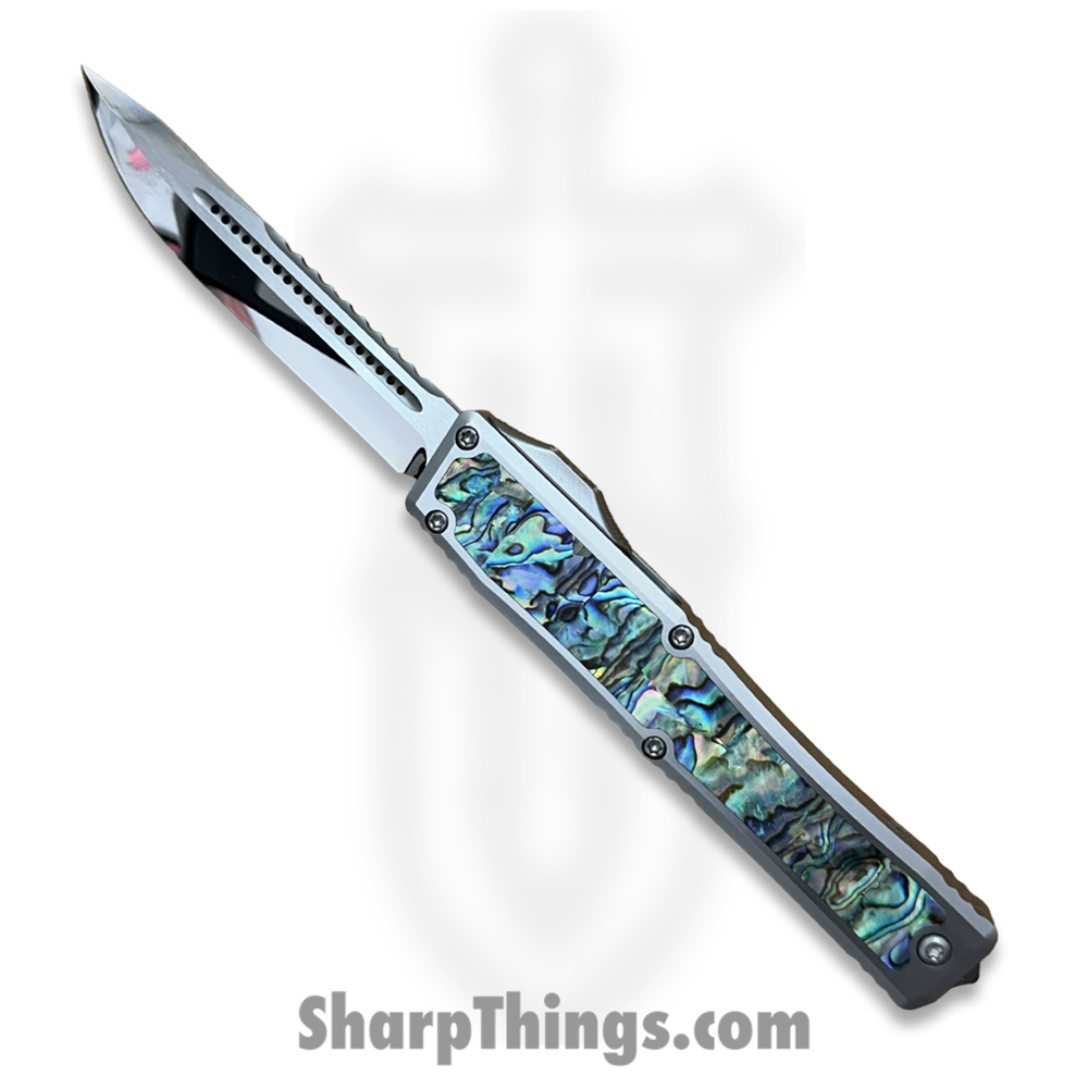 fb16e057-0ee9-44b0-b97a-38759b0be05a_NYXCSTM524_1.jpg Heretic Knives - NYXCSTM524 - NYX Custom - OTF Auto - Mirror Polish M390 Clip Point - SS Frame w Abalone Inlays - Polished - Image 1